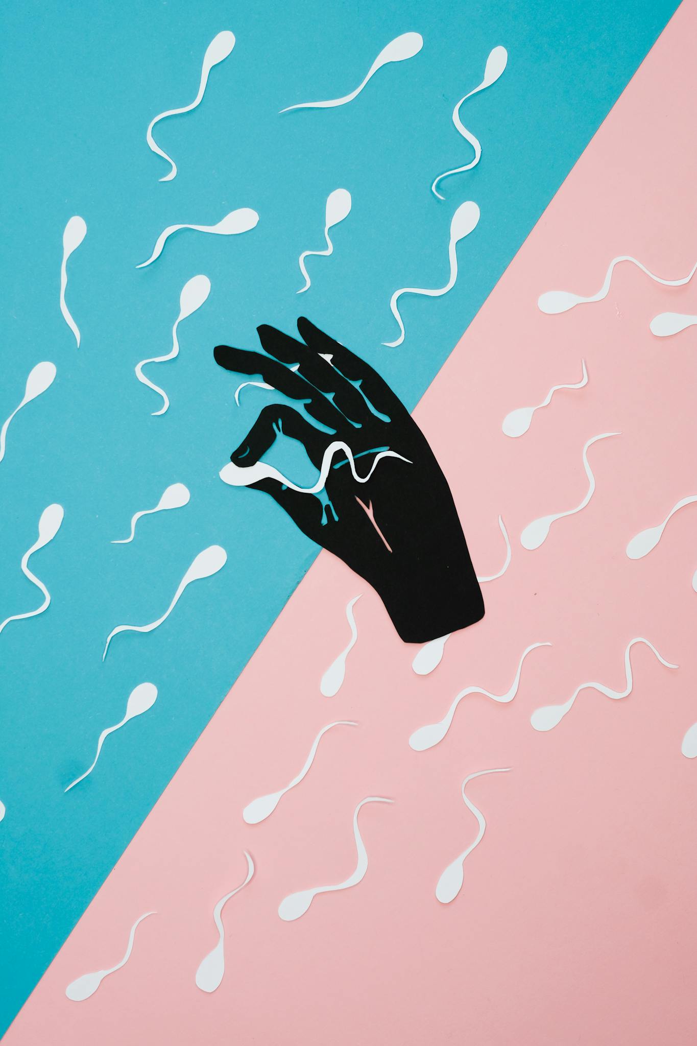 Abstract collage of a hand reaching for sperm on pink and blue background, symbolizing fertility.